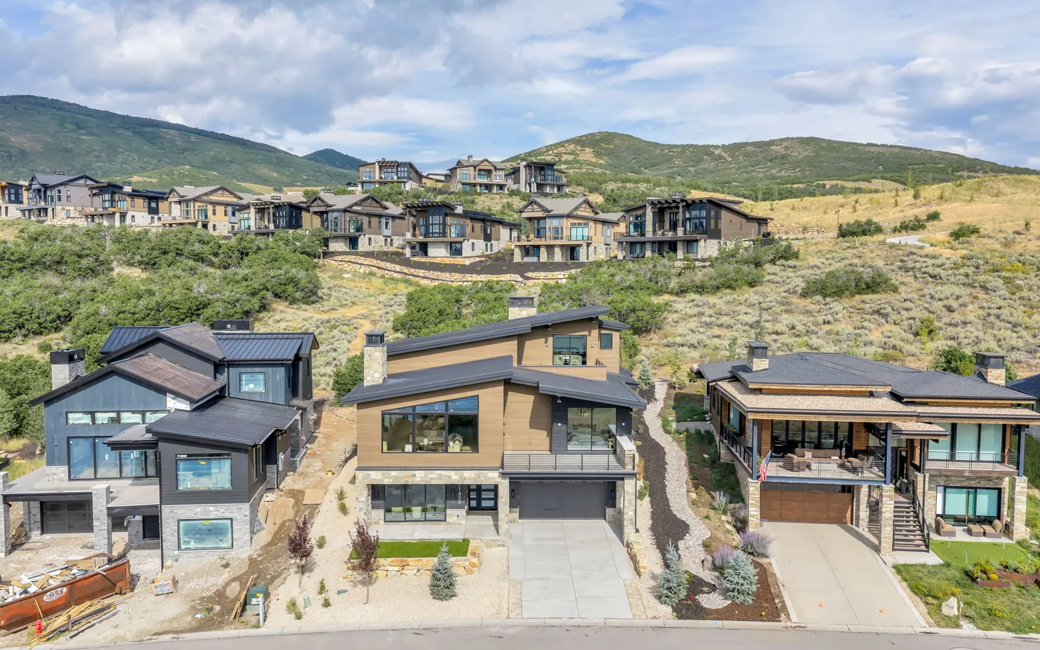 A completed Mayflower custom home with a cantilevered deck overlooking the mountains