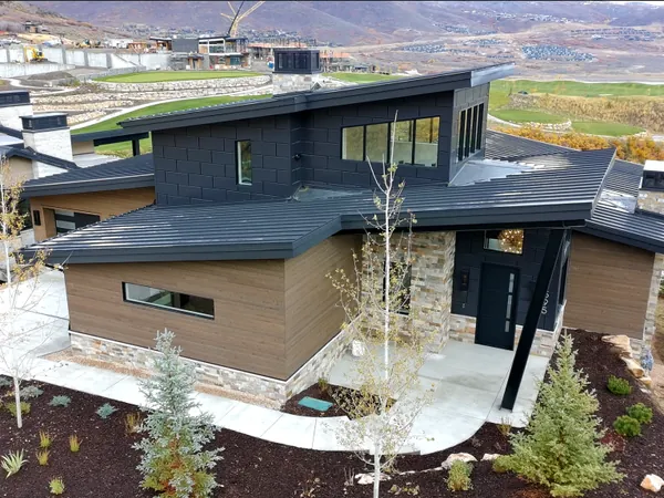 Leister, a Mayflower home in SkyRidge with dark metal panel and wood siding