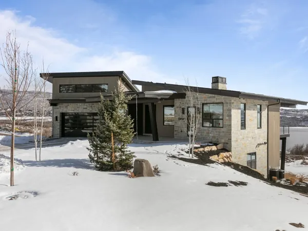 Mullins, a Mayflower home in SkyRidge with stone siding and mountain views
